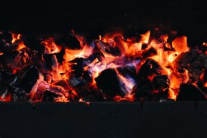 The burning coals in a brazier for meat